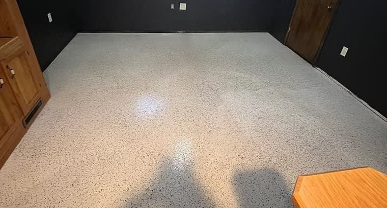 Light speckled epoxy floor in a room with dark walls